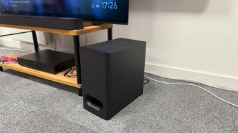 Sony Bravia Theatre Bar 6 soundbar on wooden AV rack detail of subwoofer on floor next to it