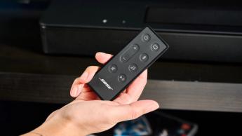 the black bose smart soundbar 2024 with remote, 2 touch controls on top, and mesh covering on top