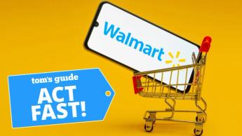 Smartphone mostrando el logo de Walmart dentro de un carrito de compras pequeño