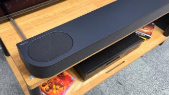 Sony Bravia Theatre Bar 6 soundbar on wooden AV rack detail of left side showing speaker and Sony logo