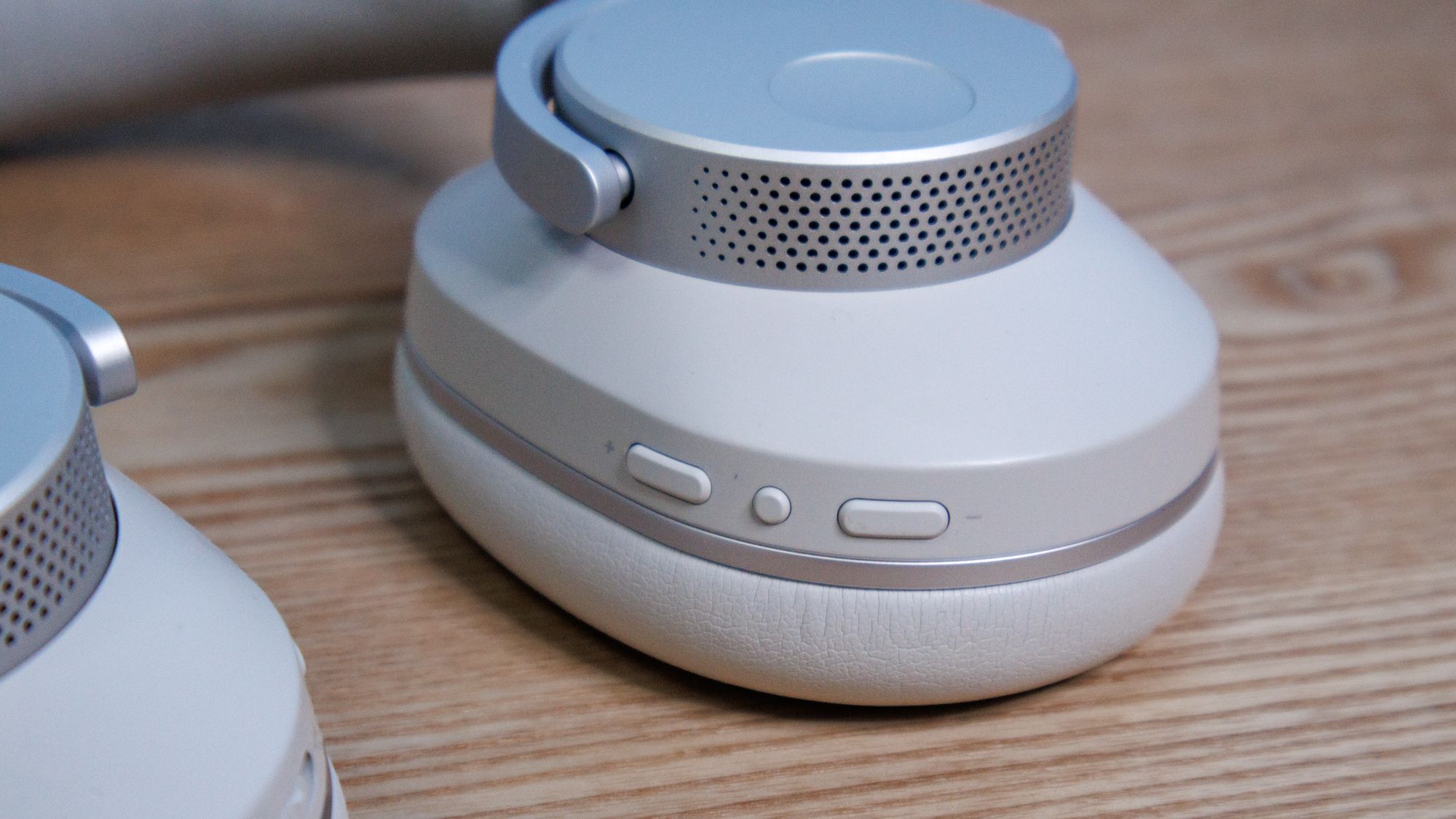 Nahaufnahme der Bedien- und Lautstärketasten an den kabellosen Cambridge Audio Melomania P100 SE Kopfhörern