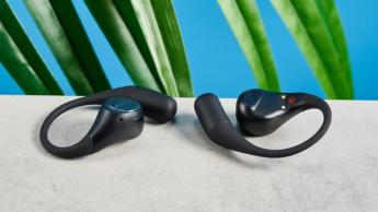 EarFun OpenJump open-ear earbuds photographed in front of a blue background.