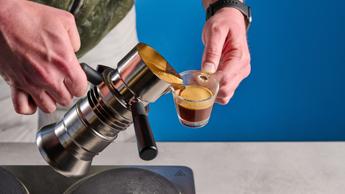 A máquina de espresso 9Barista Mk.2 exibida sobre um fundo azul sólido