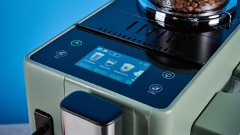 the de'longhi rivelia automatic superautomatic coffee machine in sage green with a bright LED screen, two interchangeable bean hoppers, an automatic milk frother, and a huge range of coffee recipes