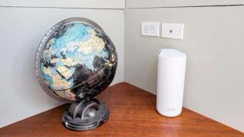 책상 위에 놓인 Netgear Orbi 873 WiFi 6E 메시 라우터