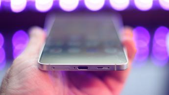 Samsung Galaxy S25 Edge-smartphone sedd underifrån med suddiga svarta ljus i bakgrunden