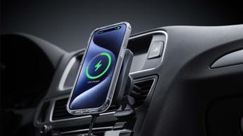 The ESR HaloLock MagSafe Car Charger Mount with CryoBoost holding an iPhone on a car dashboard.