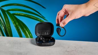 EarFun OpenJump open-ear earbuds photographed in front of a blue background.