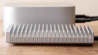 OWC Express 1M2 SSD enclosure on a table beside Apple Mac mini M4, side on