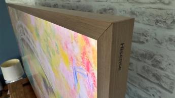 Hisense Canvas 55-inch TV with wooden frame attached and colourful art on screen