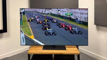 65-дюймовый OLED-телевизор LG G5 на деревянной тумбе показывает сцену из сериала Netflix «Формула-1: Гонять, чтобы выживать»