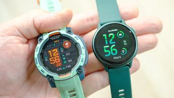 Close-up of the Garmin Vivoactive 6 smartwatch in green (right) next to the Instinct 3 in teal (left)