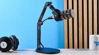 Das Rode PodMic Podcast- und Broadcast-Mikrofon auf blauem Hintergrund mit dem Rode DS2 Tischständer