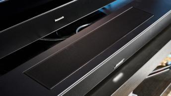 the black bose smart soundbar 2024 with remote, 2 touch controls on top, and mesh covering on top