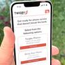 Aplikasi mobile Twigby ditampilkan pada smartphone iPhone 14