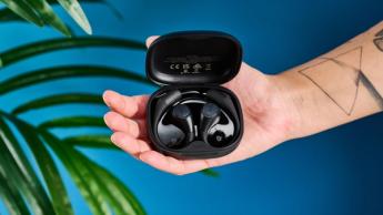 EarFun OpenJump open-ear earbuds photographed in front of a blue background.