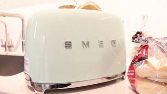 Tostadora Smeg TSF01PGUS de 2 rebanadas sobre la encimera de una cocina durante una prueba doméstica