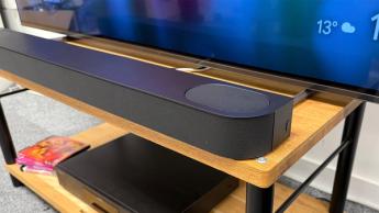 Sony Bravia Theatre Bar 6 soundbar on wooden AV rack beneath TV slight angle from right