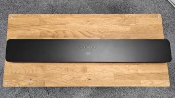Amazon Fire TV Soundbar Plus Dolby Atmos soundbar on wooden AV rack top down view