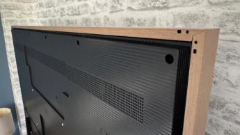 Hisense Canvas 55-inch TV showing rear of TV frame with wood-effect frame attached