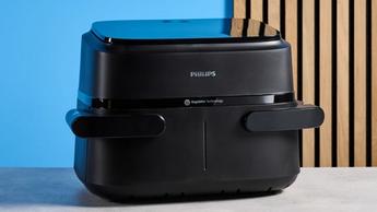 Fritadeira elétrica Philips FlexDrawer Série 1000 exibida sobre um fundo azul