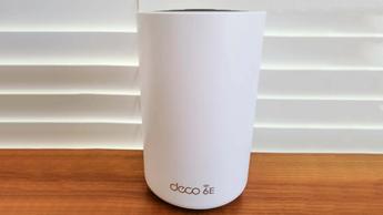 책상 위에 놓인 TP-Link Deco XE75 메시 와이파이 공유기