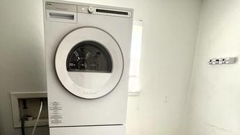 Whole ASKO Tumble Dryer T411VDW machine on top of washer