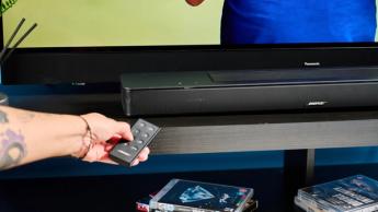 the black bose smart soundbar 2024 with remote, 2 touch controls on top, and mesh covering on top