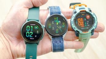 Close-up of the Garmin Vivoactive 6 smartwatch in green (left) next to the Garmin Forerunner 165 (center) and Garmin Instinct 3 (right)