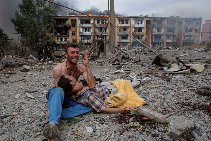 2008년 8월 9일 그루지야에서 트빌리시로부터 80km 떨어진 고리에서 폭격을 받은 그루지야 남성이 친척의 시신 옆에서 울고 있다. (사진: Gleb Garanich/Reuters)