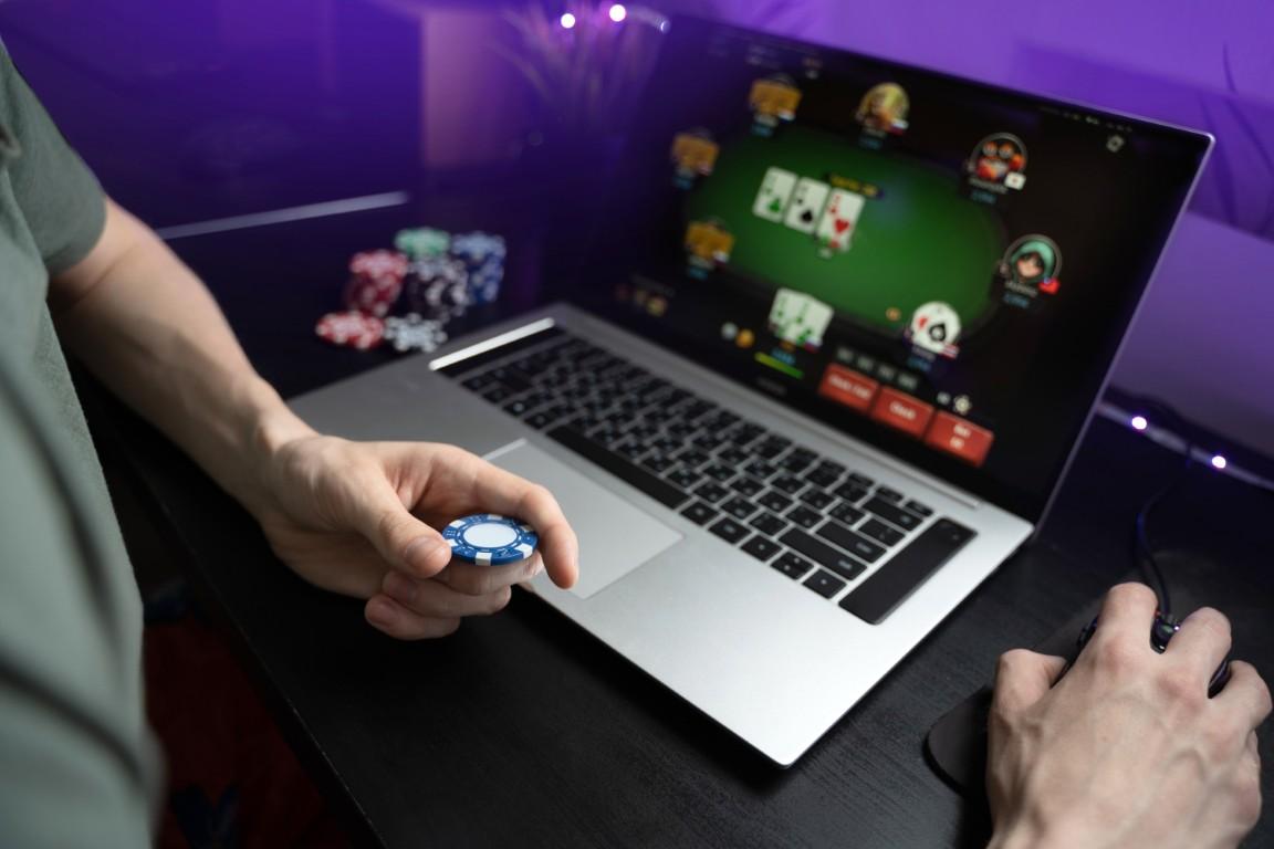young-man-play-online-poker-laptop