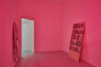 Return of the Lepidopters, 2019, 24 Graphic novels and comics, wood display board, flatscreen television with digital file, plastic and cotton fiber bead curtain in green, neon pink-lit room, chair, Dimensions variable
(undefined), Mark von Schlegell, Jan Kaps, Cologne