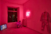 Return of the Lepidopters (detail), 2019, 24 Graphic novels and comics, wood display board, flatscreen television with digital file, plastic and cotton fiber bead curtain in green, neon pink-lit room, chair, Dimensions variable
(undefined), Mark von Schlegell, Jan Kaps, Cologne