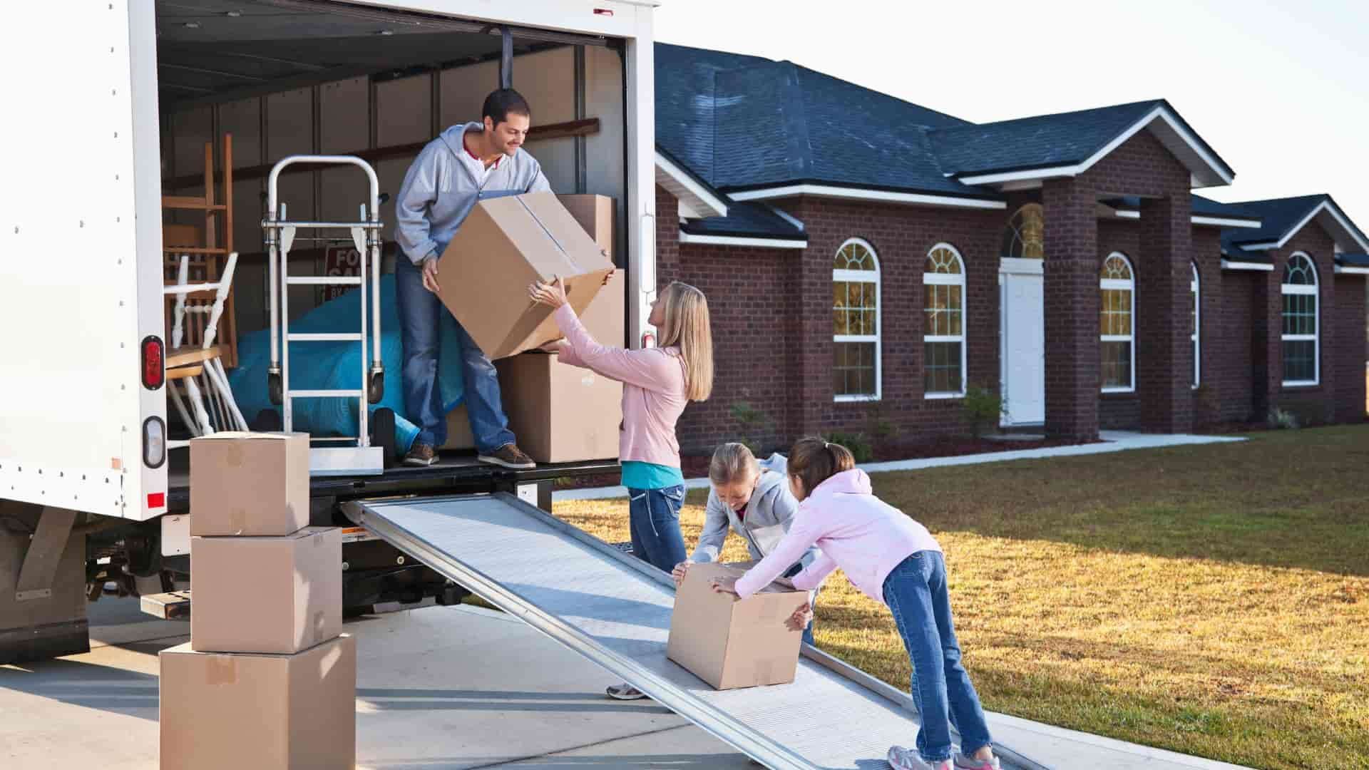 A family unpacking their belongings from a cross town movers moving truck in nampa