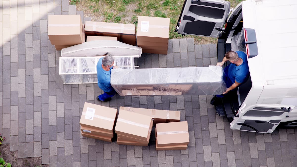 2 people moving boxes into truck