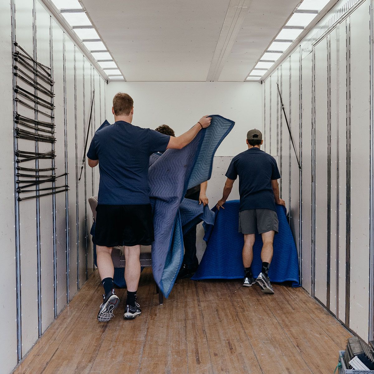 Two Cross Town Movers Employees packing a truck