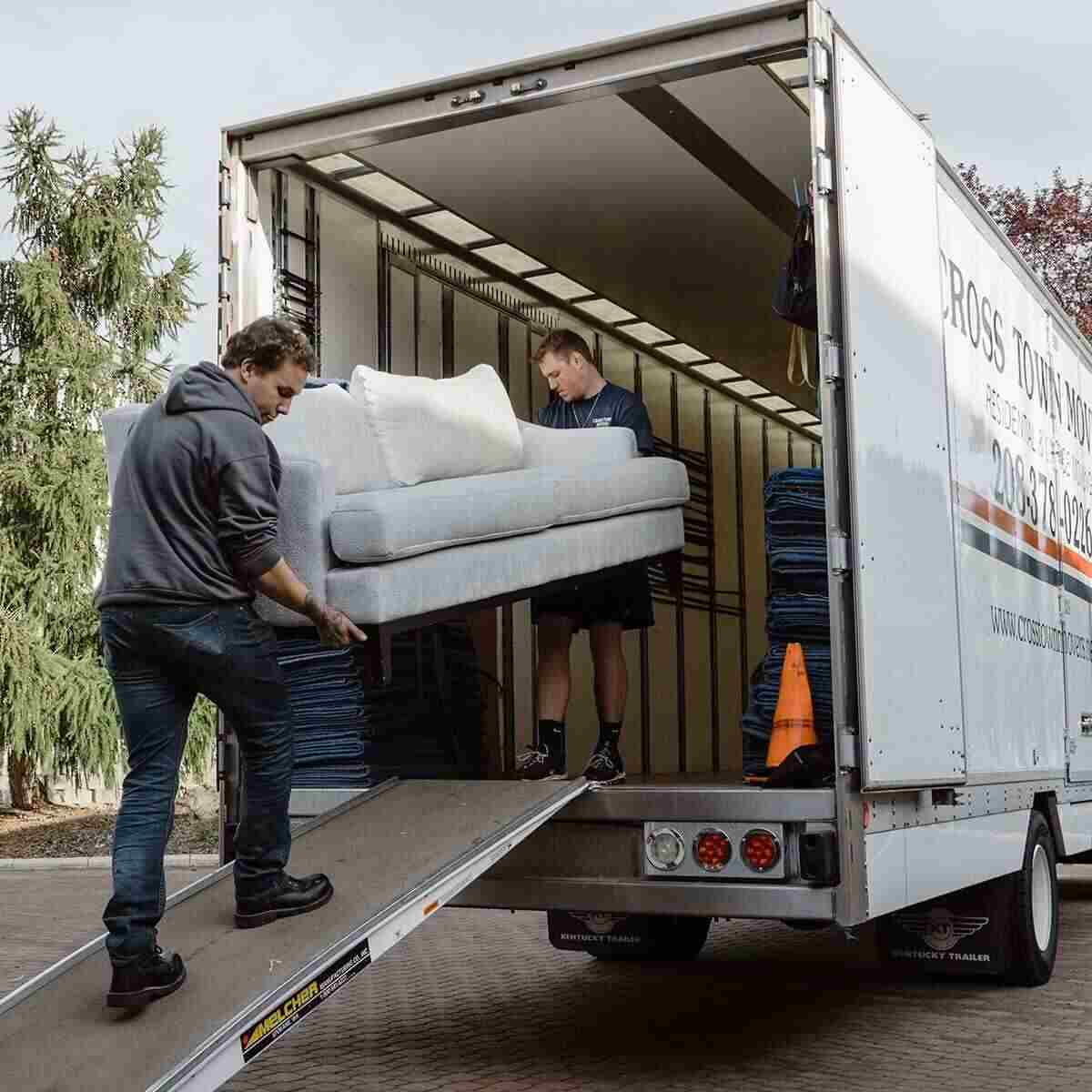Two Cross Town Boise Movers Employees moving a couch