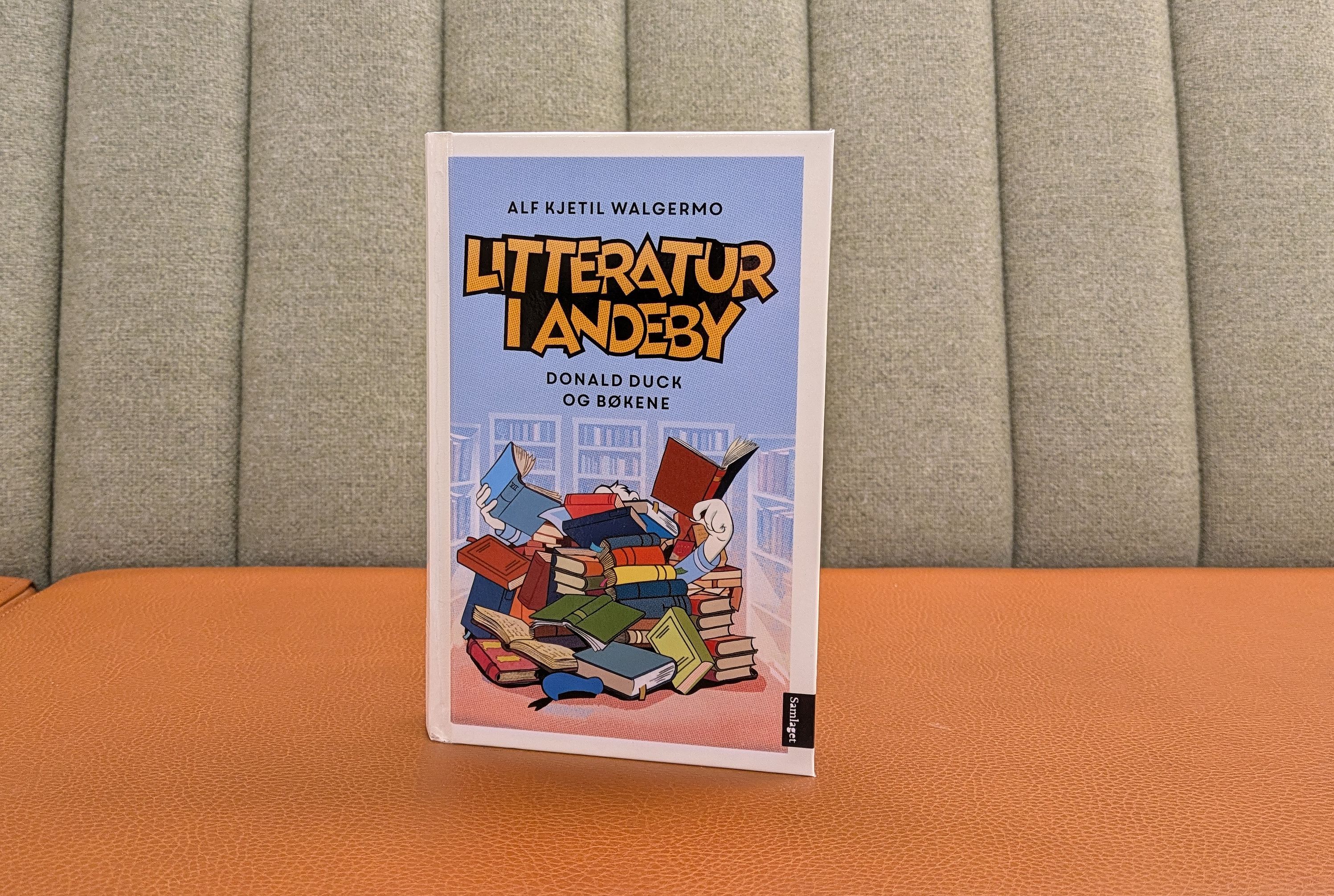 Boka Litteratur i Andeby av Alf Kjetil Walgermo stående i en sofa