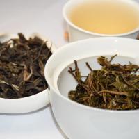 Comprehensive quality evaluation of EU-compliant raw Pu-erh tea, displaying dry leaves, bright golden liquor, and intact infused leaves in white teaware.