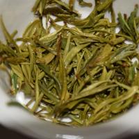 Quality inspection of wholesale Huoshan Yellow Bud: close-up of infused leaves.