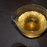 Professional quality check of Mi Lan Xiang Dan Cong oolong, showing expanded wet leaves inside a traditional Yixing clay teapot.