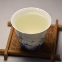 Brewed infusion of wholesale Huoshan Yellow Bud yellow tea showing its bright color.