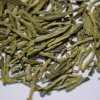 Wholesale premium flat Dragon Well loose green tea leaves with vibrant spring color.
