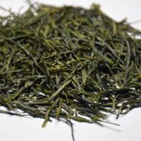 Macro inspection of wholesale organic Enshi Yulu green tea, highlighting its uniform and pristine pine-needle shaped dry leaves.