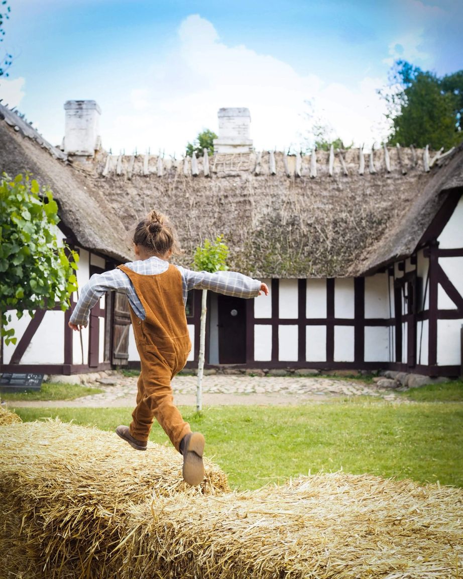Girl jumps on hay