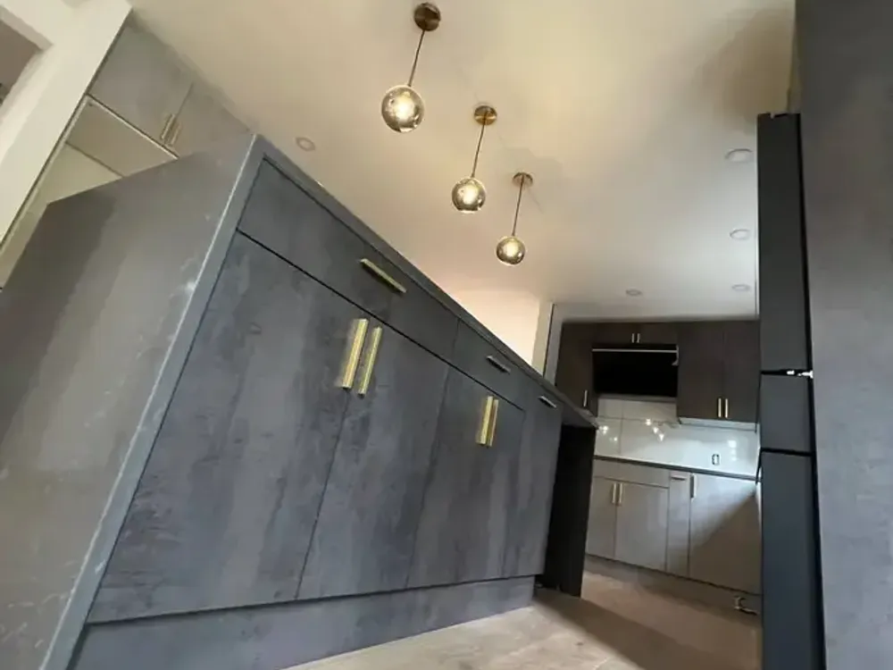 Gray concrete-style kitchen cabinets with pendant lighting Bellevue