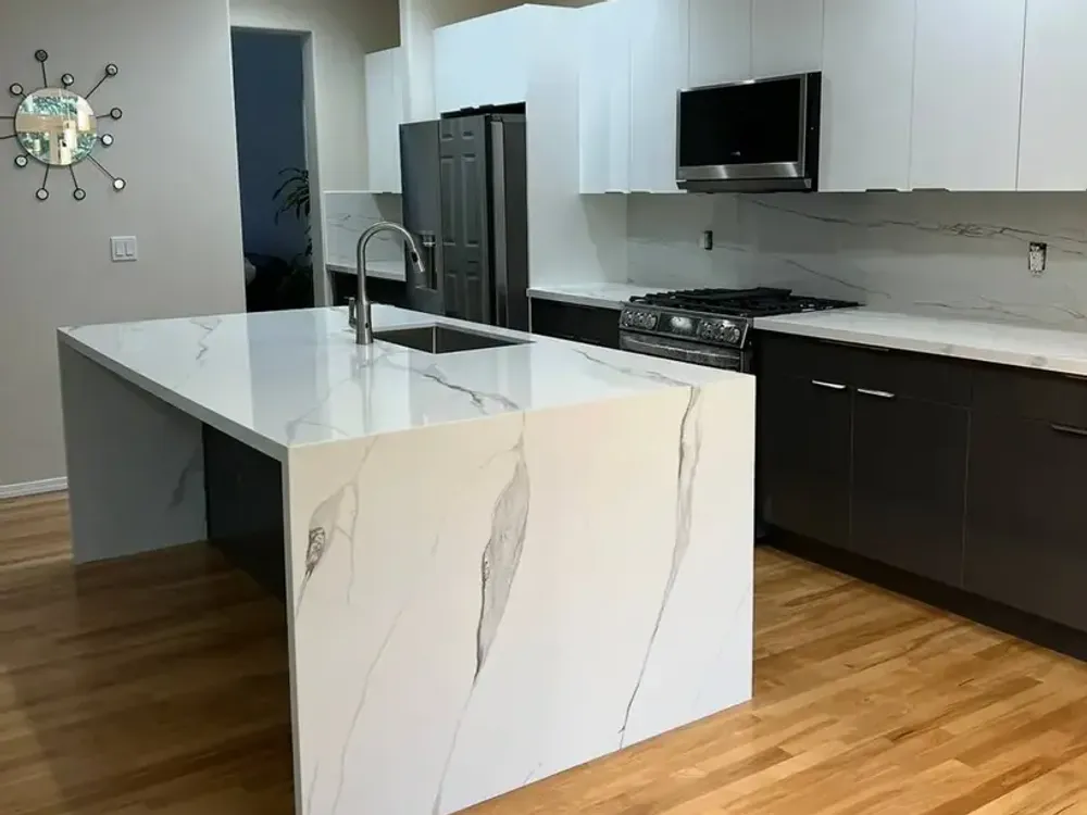 Gray marble countertop island with fireplace accent wall