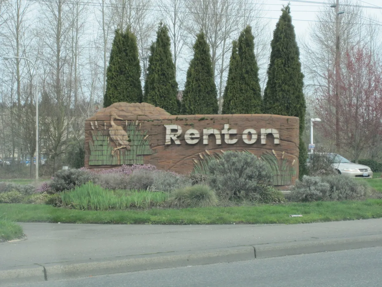 Welcome to Renton sign with sculpted evergreens