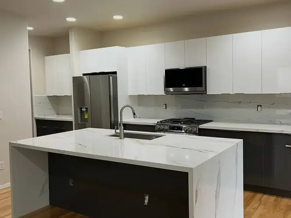 Super white quartzite countertop with dark tile floor