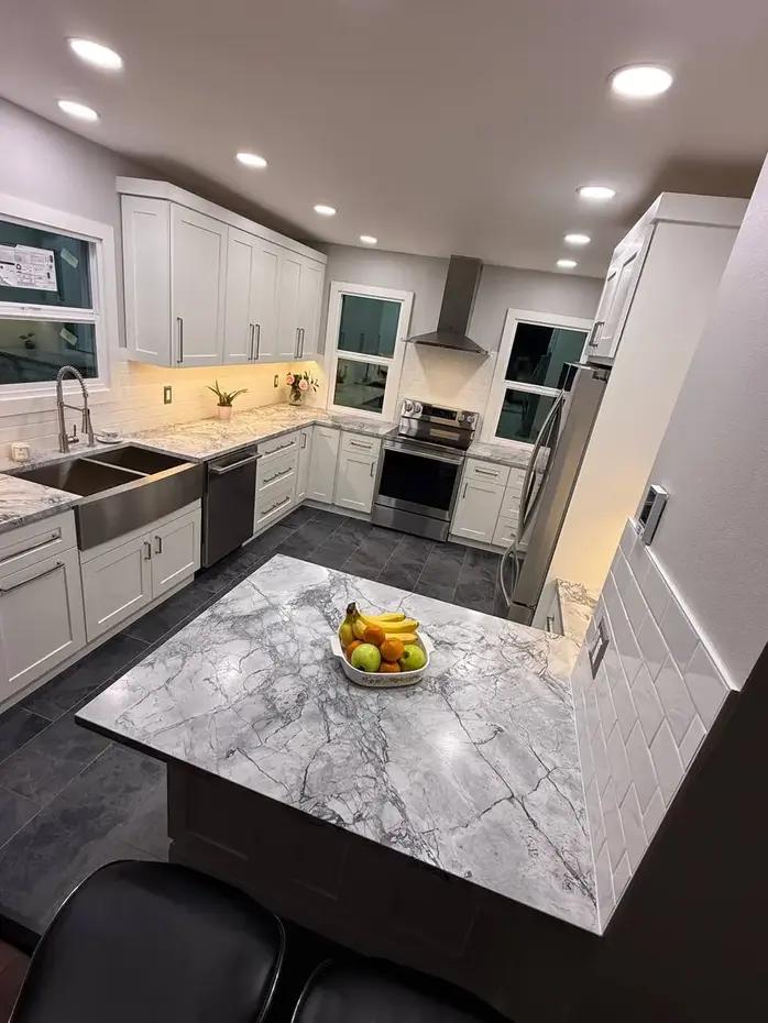 White quartz countertop with waterfall edge and dark cabinets